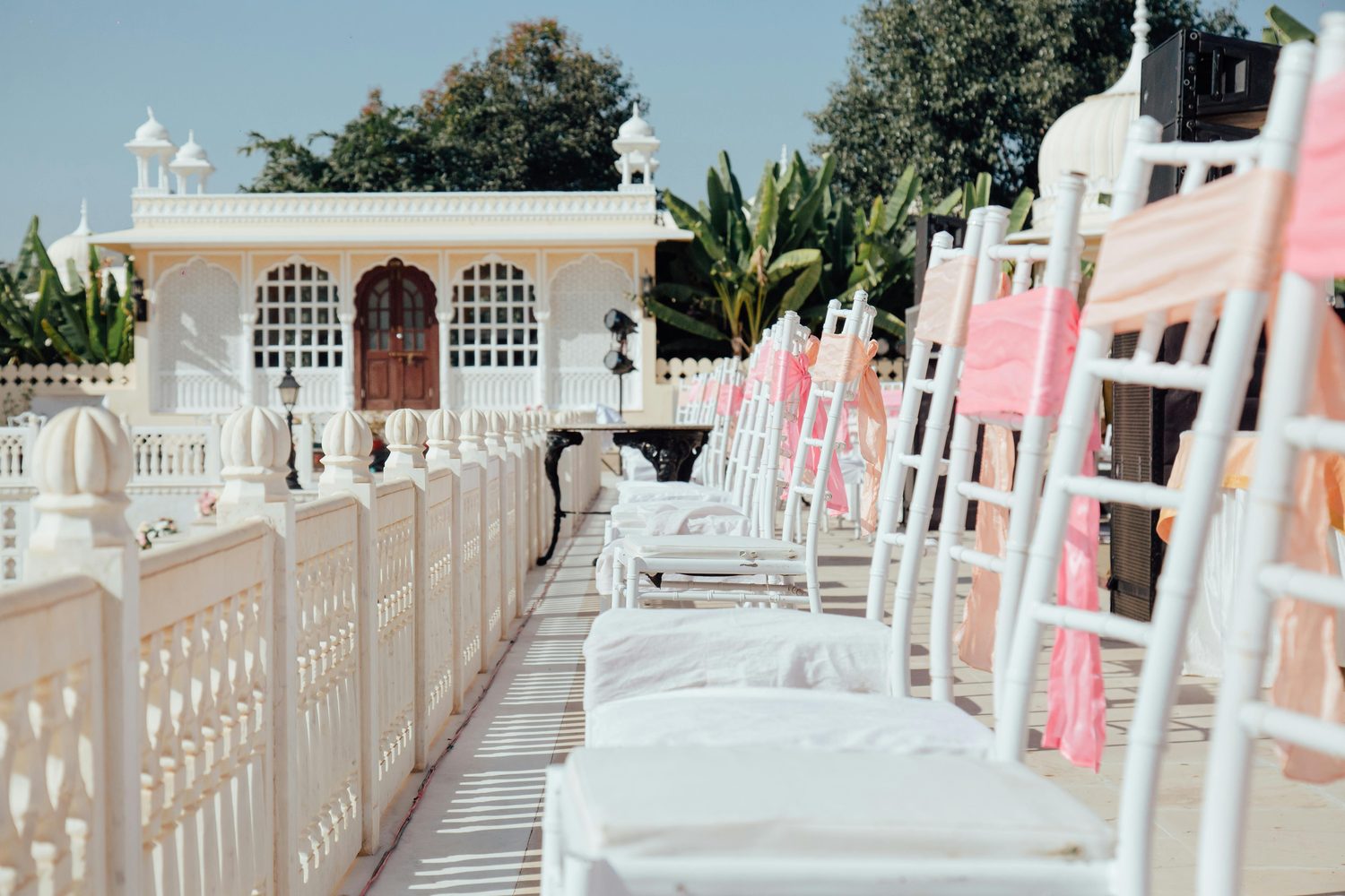 Rows of white chairs set up outdoors before an event begins
