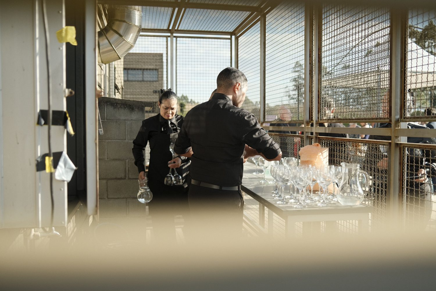 Event Ally helpers setting up glassware before an event